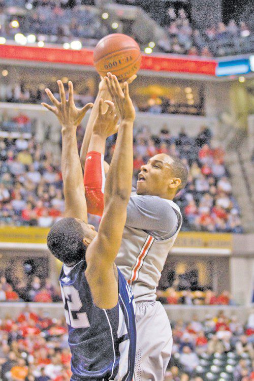 Ohio State’s sensational freshman Jared Sullinger, 0, shoots over Penn State’s Andrew Jones, 22, in taking the men’s Big Ten Tournament title 71-60. Sullinger was named the tournament’s Most Outstanding Player. (Photo/W. Thomas)