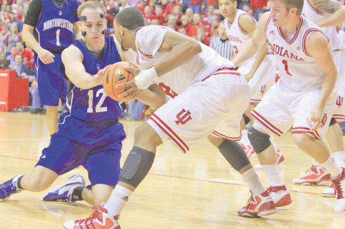 Indiana forward Christian Watford, 2, battles for the ball against Northwestern center Luka Mirkovic, 12. Watford finished the night with 11 points, 1 steal, and 2 rebounds. (Photo/R. Foster Sharif)
