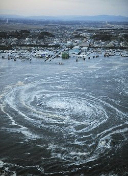 Tsunami waves swirl near a port in Oarai, Ibaraki Prefecture (state) after Japan was struck by a strong earthquake off its northeastern coast Friday, March 11, 2011. (AP Photo/Kyodo News) JAPAN OUT, MANDATORY CREDIT, FOR COMMERCIAL USE ONLY IN NORTH AMERICA, NO SALES