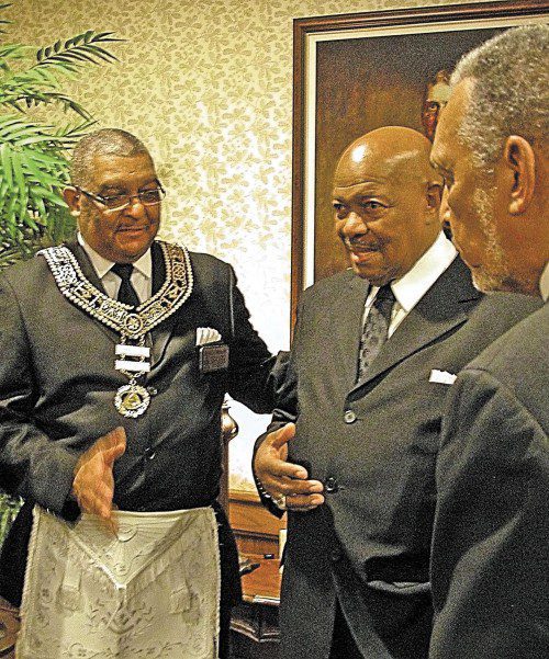 Darrell E. Morton (left), Most Worshipful Grand Master of the Prince Hall Grand Lodge of Indiana, discusses memories of Algie Oldham Sr. with members.