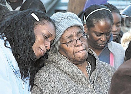 Relatives, friends and others have only tears to express their feelings over the senseless violence that snuffed out the life of another promising young man. The shooting victim’s aunt, Karen Grundy (left), leans on the shoulder of his grandmother, Anna Hall, during the vigil. (Photos/L. Blaylock)