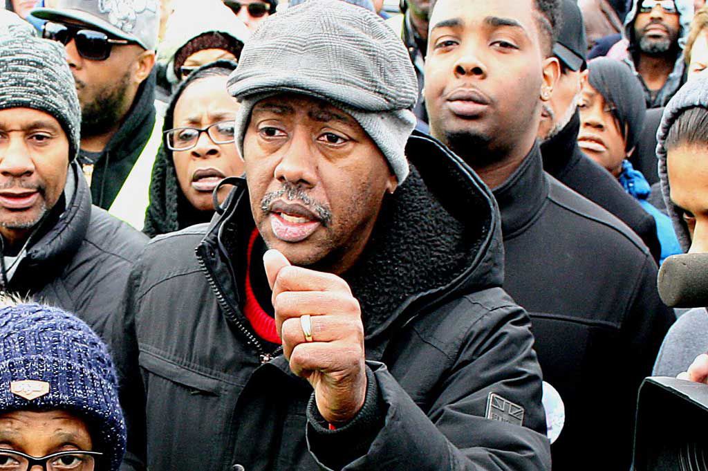 

<p>Rev. Charles Harrison, Ten Point Coalition leader, holds his fist in support of the hundreds that participated in Let’s March for Malaysia. (Photo/Curtis Guynn)</p>
<p>“><figcaption class=