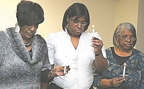 Pictured are members paying tribute to charity founders with a candle lighting ceremony. This year's luncheon theme was 