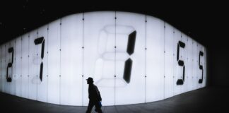 photo of man walking near LED signage