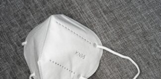 white leather sling bag on brown textile