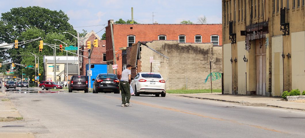 A man crosses 10th street in Indianapolis