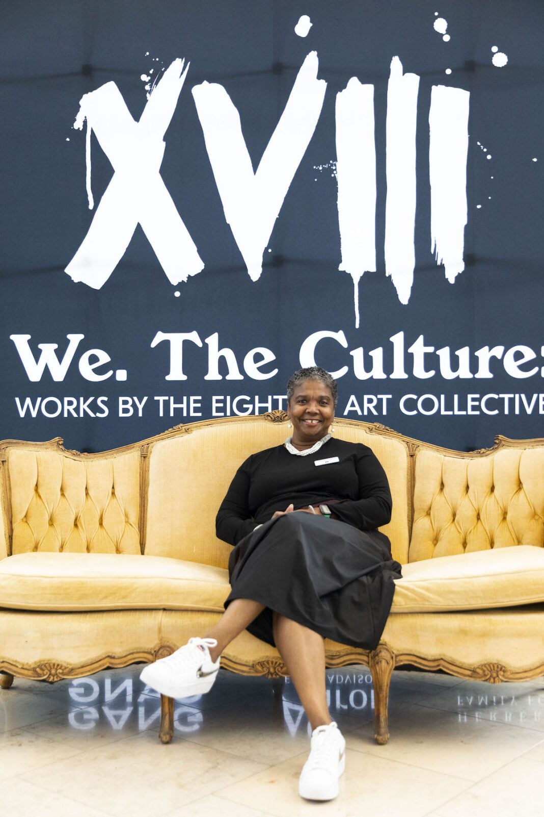 Newfields CEO and President Colette Pierce Burnette poses on a couch in front of the 