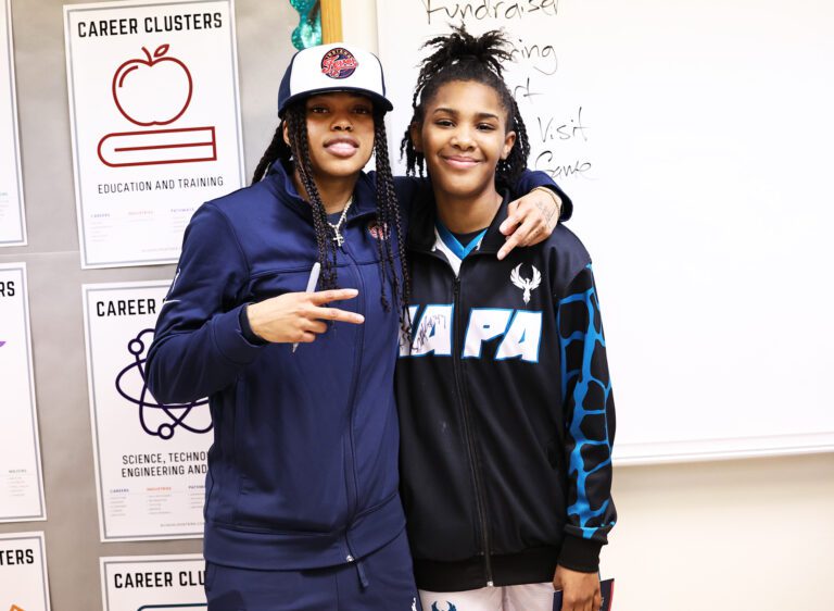 WNBA player Destanni Henderson speaks to the middle school basketball players