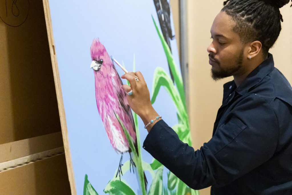 Kyng Rhodes painting a mural for the Philadelphia Flower Show