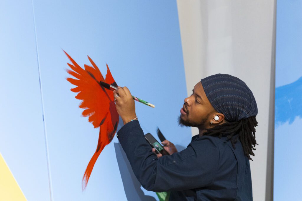 Kyng Rhodes painting a mural for the Philadelphia Flower Show