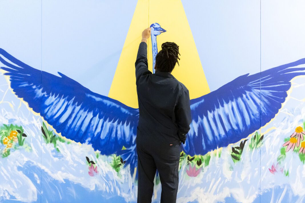 Kyng Rhodes painting a mural for the Philadelphia Flower Show