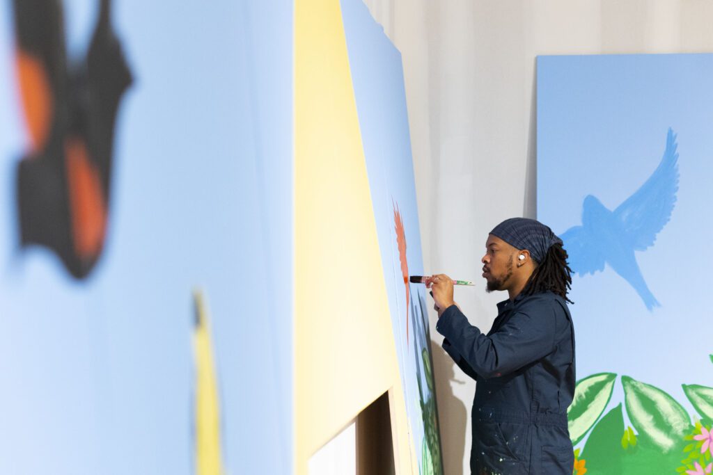 Kyng Rhodes painting a mural for the Philadelphia Flower Show