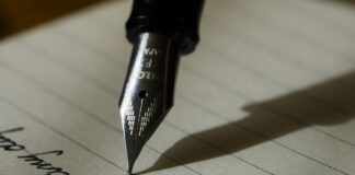 fountain pen on black lined paper