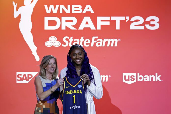 South Carolina's Aliyah Boston, right, poses for a photo with commissioner Cathy Engelbert after the Indiana Fever selected her first overall at the 2023 WNBA Draft.