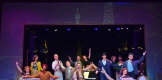 The Company of Beef & Boards Dinner Theatre’s production of “An American in Paris,” sings “I Got Rhythm.”