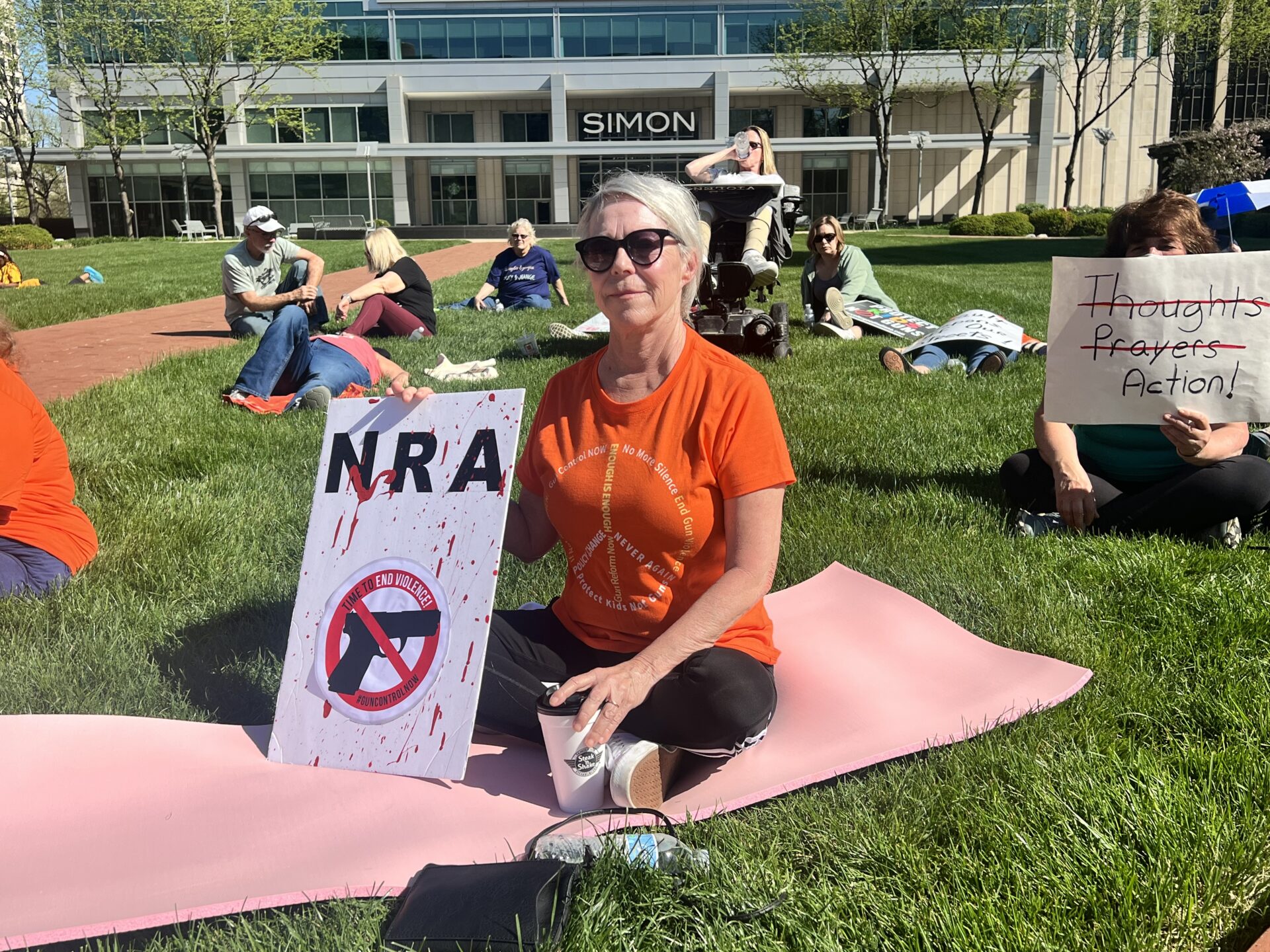 Demonstrators took turns reading the names of thousands of children killed by gun violence while others laid out in the grass to symbolize their deaths.