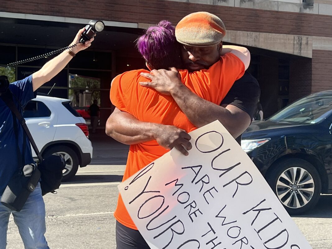 Activist, Jauston “TheKingTrill” Huerta hugging a fellow protester these are our children