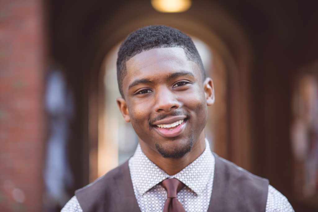 David Lewis—a Harvard Kennedy School student and organizer of the Black Men at Harvard project, including the April 2023 group photoshoot—pictured in front of Wigglesworth Hall in Cambridge, Massachusetts. (Photo/Corban Swain)