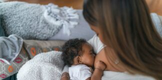 A woman breastfeeding a newborn. For IBBC.