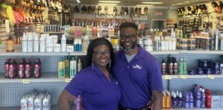 Shirley and Cecil “Dapo” Milligan stand in front of their store Urban Beauty Supply at 5333 E Thompson Rd, Indianapolis, IN 46237 (Photo/ Jade Jackson)