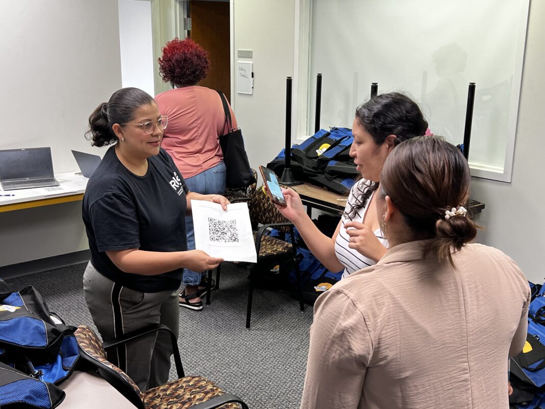 Several parents and their children came to the RISE INDY building June 15, 2023, to pick up bags for the Freedom Readers Champion program.