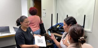Several parents and their children came to the RISE INDY building June 15, 2023, to pick up bags for the Freedom Readers Champion program.