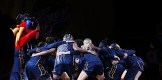 A photo of the Indiana Fever getting rowdy during the pregame with mascot Freddie Fever against the Chicago Sky on July 2 at Gainbridge Fieldhouse.