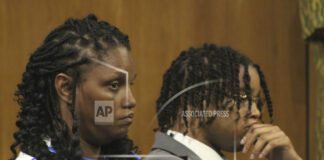 D'Monterrio Gibson, right, and his mother, Sharon McLendon, await the start of the trial of two white men charged in an attack on Gibson, a FedEx employee who was making a delivery, Thursday, Aug. 17, 2023, in Brookhaven, Miss. The judge declared a mistrial of the men who were charged with attempted first-degree murder, conspiracy and shooting into the vehicle driven by Gibson. (Hunter Cloud/The Daily Leader via AP)