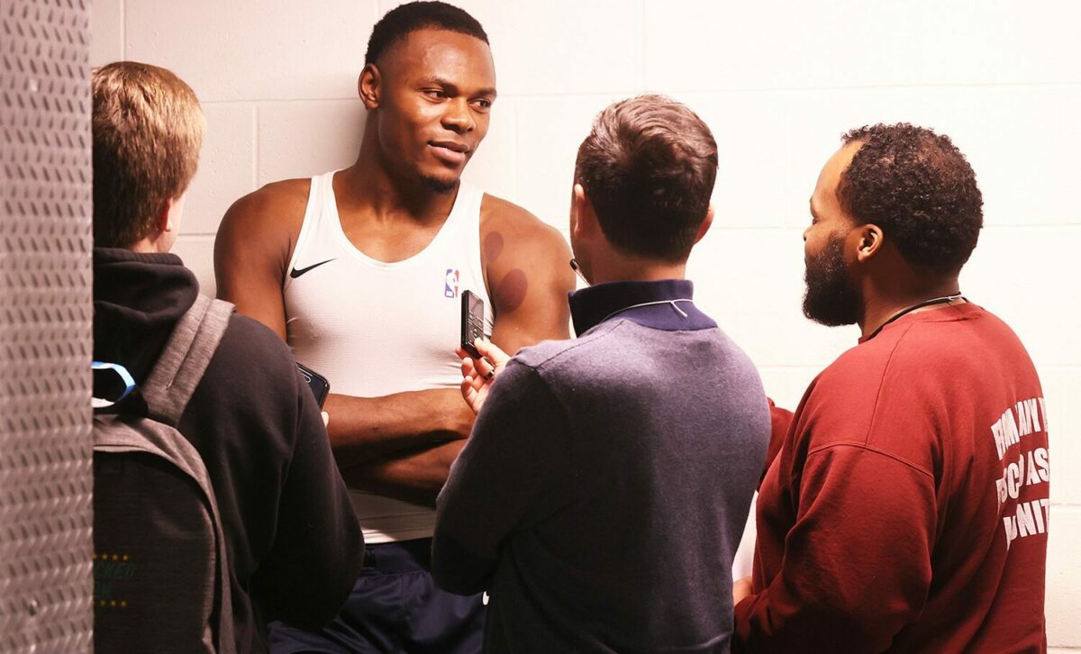 An Indiana Mad Ants basketball player talking to reporters after a game.