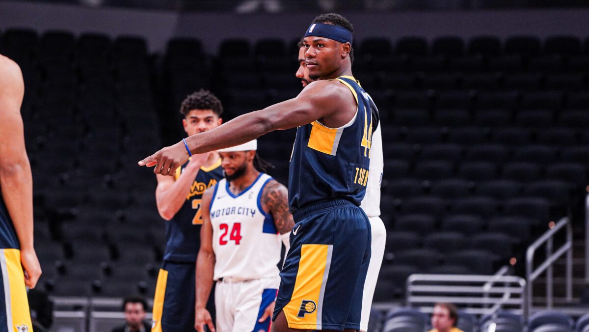 NBA G league player pointing during a basketball game.