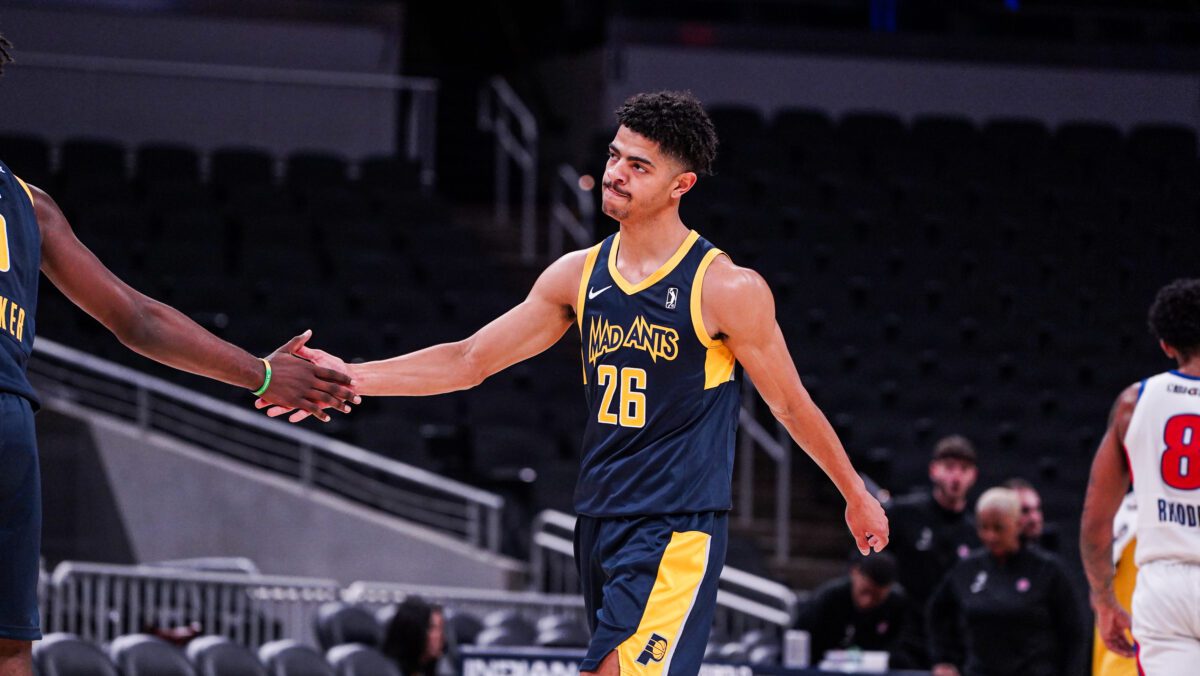 NBA G league player celebrating during a basketball game.