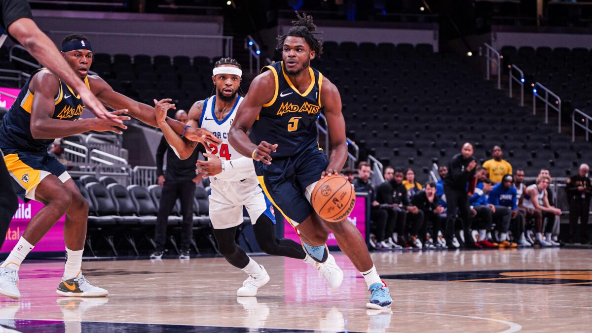 NBA G league player dribbling during a basketball game.