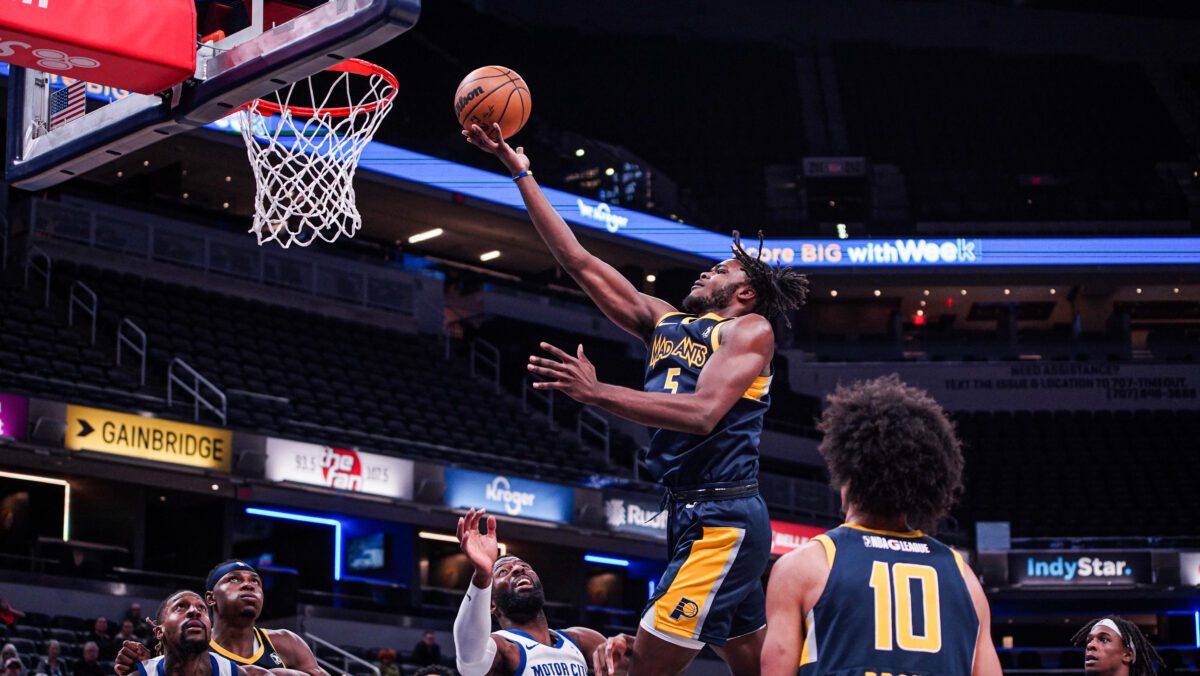 NBA G league player making a layup during a basketball game.