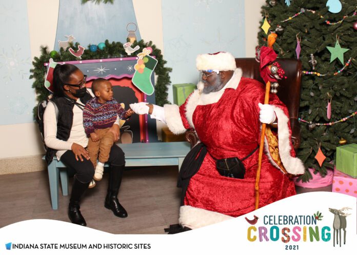 Santa poses for pictures with a family during Celebration Crossing at the Indiana State Museum. (Photos provided/Josiah McCruiston)