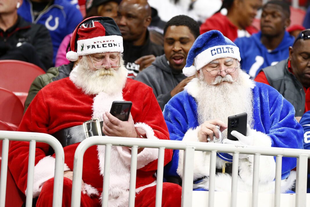 Two different santa clauses during a football game between the Indianapolis Colts and Atlanta Falcons