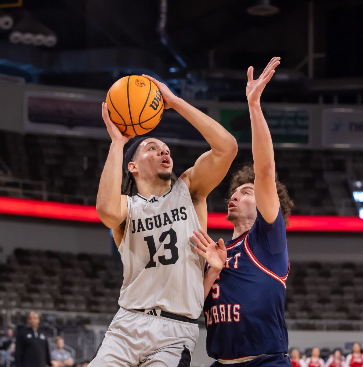 IUPUI Jaguar D.J. Jackson (13) absorbs the contact during their game against the Robert Morris Colonials on January 20, 2024 at Indiana Farmers Coliseum. (Photo/Walt Thomas)