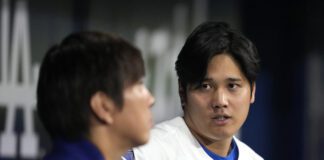 Los Angeles Dodgers' designated hitter Shohei Ohtani, right, chats with his interpreter Ippei Mizuhara during an exhibition baseball game between Team Korea and the Los Angeles Dodgers at the Gocheok Sky Dome in Seoul, South Korea, Monday, March 18, 2024. Ohtani’s interpreter and close friend has been fired by the Dodgers following allegations of illegal gambling and theft from the Japanese baseball star. (AP Photo/Lee Jin-man)