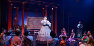 Anna Leonowens (Hannah Louise Fernandes) tells the royal children that they’re precisely her “cup of tea” as she sings “Getting To Know You” in Beef & Boards Dinner Theatre’s production of Rodgers and Hammerstein’s The King and I, now on stage through May 19.(Photo/Indy Ghost Light)