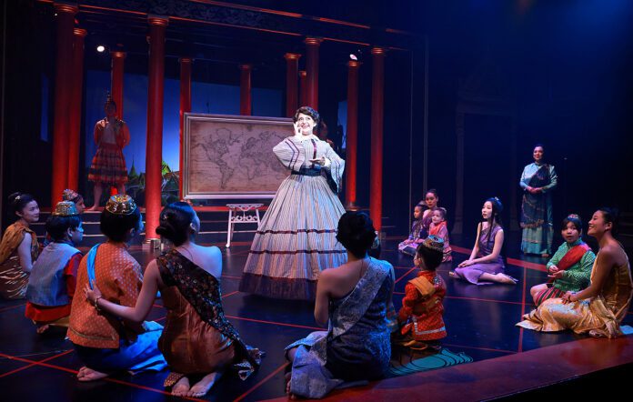 Anna Leonowens (Hannah Louise Fernandes) tells the royal children that they’re precisely her “cup of tea” as she sings “Getting To Know You” in Beef & Boards Dinner Theatre’s production of Rodgers and Hammerstein’s The King and I, now on stage through May 19.(Photo/Indy Ghost Light)