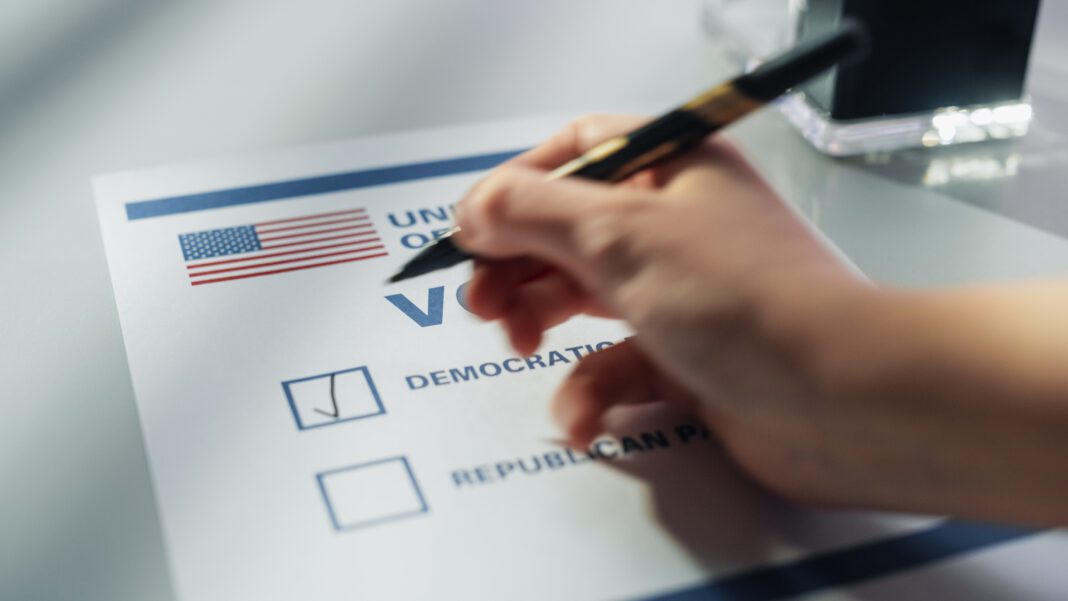 Close Up View on an Anonymous Person Filling Out a Ballot in a Voting Booth on the Day of National Elections in the United States of America. Man or Woman Choosing to Vote for Democratic Party (Photo/Getty Images)