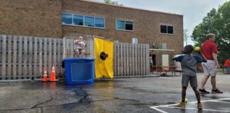 A kid attempting to dunk a member of the MLK Center staff during their community block party on May 17, 2024 at the MLK Center, located at 40 W. 40th Street in Indianapolis, IN. (Photo/Noral Parham)