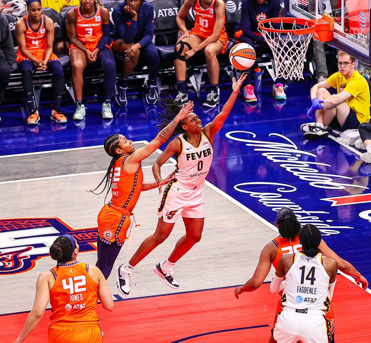 Indiana Fever guard Kelsey Mitchell puts up a layup as Connecticut Sun guard Ty Harris attempts to contest during their game on May 20, 2024 at Gainbridge Fieldhouse in downtown Indianapolis, IN. (Photo/David Dixon)