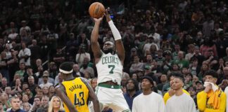 Boston Celtics guard Jaylen Brown (7) puts up a 3-point shot to score and tie the game against the Indiana Pacers with seconds left in Game 1 of the NBA Eastern Conference basketball finals, Tuesday, May 21, 2024, in Boston. (AP Photo/Charles Krupa)