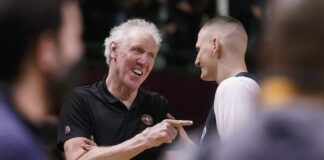 a photo of Bill Walton and Nikola Jokic talking and smiling