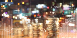 Double explosure with businesss charts of graph and rows of coins for finance at night city background.