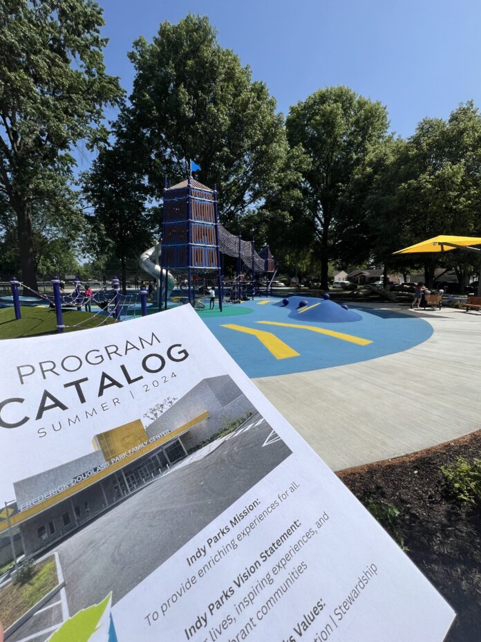 A program catalog displayed in front of a children's playground