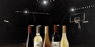 a group of wine bottles on a hardwood floor.