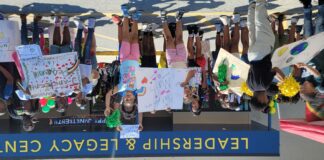kids holding protest signs during Juneteenth Peace Walk.
