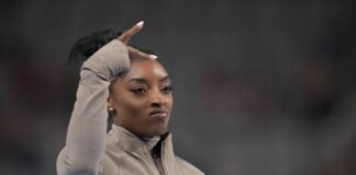 Simone Biles performing the 'peace' sign following the winning of a national title ahead of the 2024 Paris Olympics