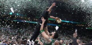 NBA player picking up son during NBA Finals